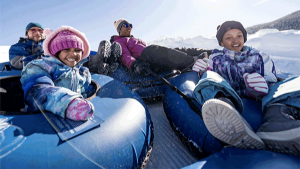 4 Kids in sledding ubes at the Frisco Adventure Park