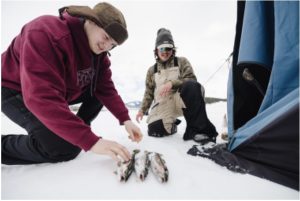 Young teen with fish caught ice fishing in Dillon